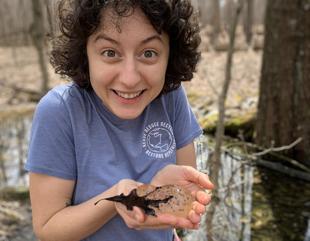 Eyes wide, Julia marvels at the amphibian eggs she's holding, exploring the first signs of new life in vernal pools during springtime in Nazareth, Kentucky.