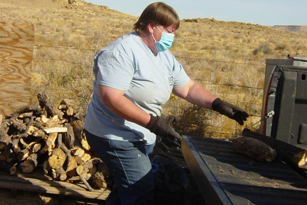 Sr. Michele Woodruff of the Adorers of the Blood of Christ helps deliver firewood to homebound sick, elderly and disabled Navajo people living near Crownpoint, New Mexico. She and Sr. Maureen Farrar, also a member of the Adorers of the Blood of Christ, or