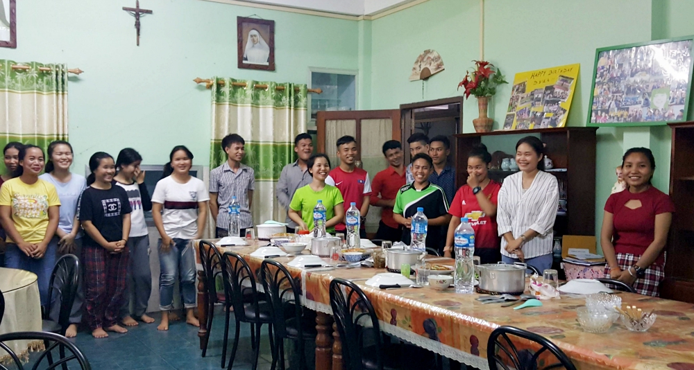 Some of the 48 students currently living at the Nazareth Center pose for a photo. The center provides them housing while they are enrolled in an onsite sewing program or in offsite classes. (Mayhoua Moua)