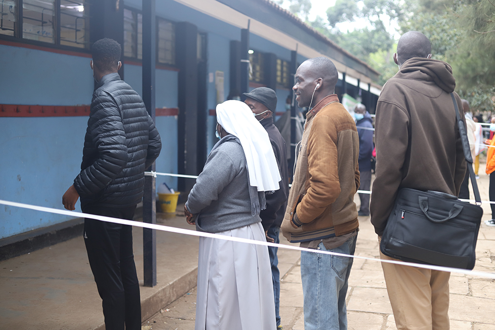 Voters, including religious sisters, queue to vote during Kenya's Aug. 9 general election at the Milimani Primary School polling station in Nairobi. Millions of Kenyans started lining up at their polling stations hours before the official opening time to 