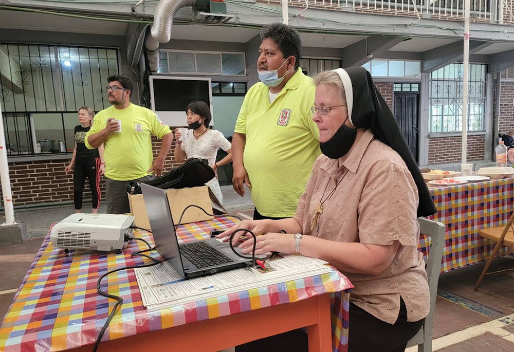 Felician Sr. Maria Louise Edwards (right), Ely Ortiz, president of the Aguilas del Desierto (center) and Aguilas volunteer Maurizio Vitela (left) give a presentation in June at a migrant shelter in Mexico City. (Courtesy photo)