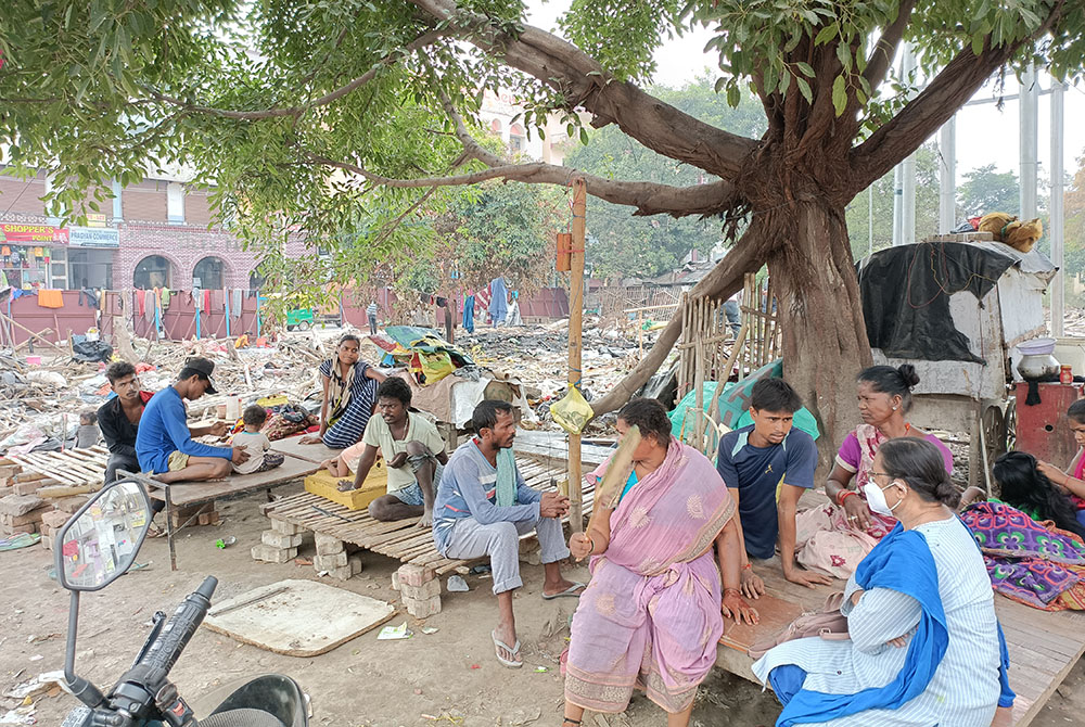 People sit at the site of their demolished homes Oct. 9 in Malaai Pakkdi, a settlement in Kankarbagh, Patna city, in Bihar state, in India. (Courtesy of Dorothy Fernandes) People sit at the site of their demolished homes Oct. 9 in Malaai Pakkdi, a settlement in Kankarbagh, Patna city, in Bihar state, in India. (Courtesy of Dorothy Fernandes)