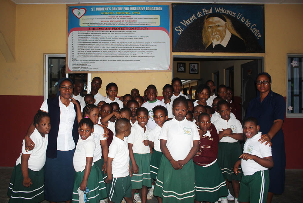 Daughters of Charity of Saint Vincent de Paul and children living with disabilities gather outside the school administration block in Uyo, state capital of Akwa Ibom in Southern Nigeria. (Kelechukwu Iruoma)