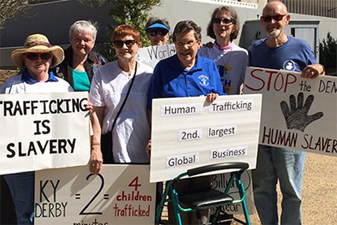 Janet M. Peterworth, center in blue shirt, is pictured among several Ursuline Sisters and associates at a public event in Louisville, intended to raise awareness about human trafficking in the area during the Kentucky Derby. (Courtesy of the Ursuline Sist Janet M. Peterworth, center in blue shirt, is pictured among several Ursuline Sisters and associates at a public event in Louisville, intended to raise awareness about human trafficking in the area during the Kentucky Derby. (Courtesy of the Ursuline Sist
