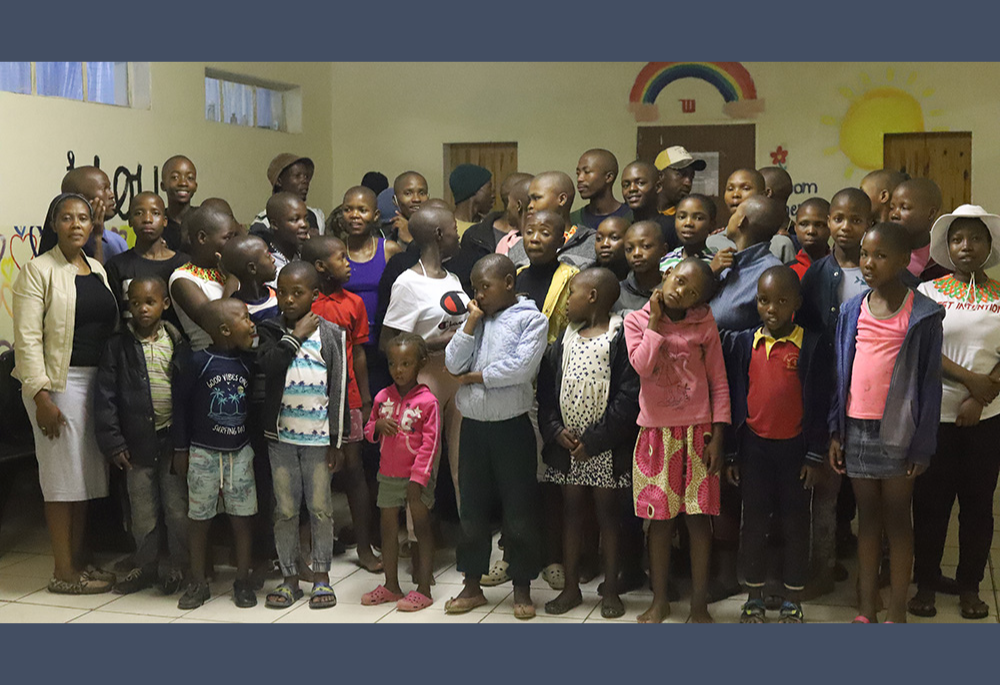 Sr. Eusebia Maselitso Lerotholi, a member of Handmaids of Christ the Priest, with the children at Andrew Blais Orphanage Home. Lerotholi founded the orphanage in 2013 to help homeless and orphaned children have a home and access to education. (GSR)