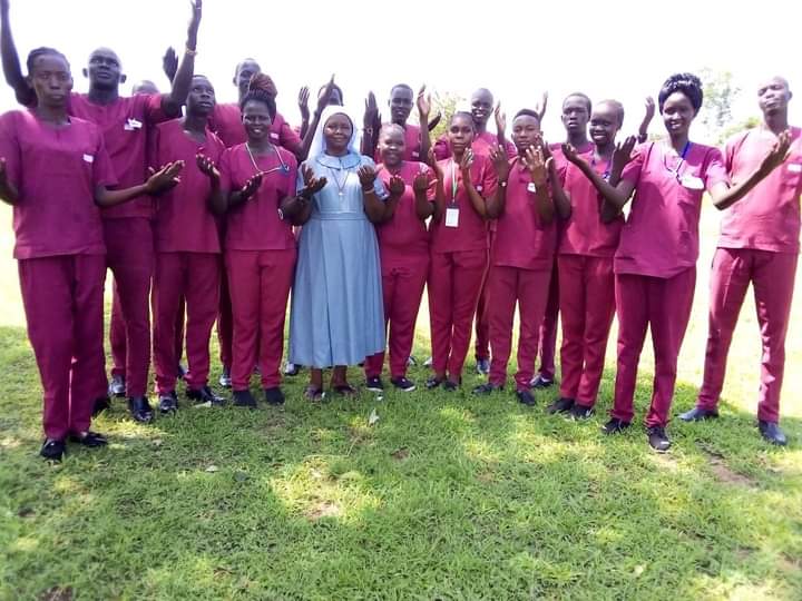 Sr. Regina Roba, in blue, with Catholic Health Training Institute students (Courtesy of Friends in Solidarity)