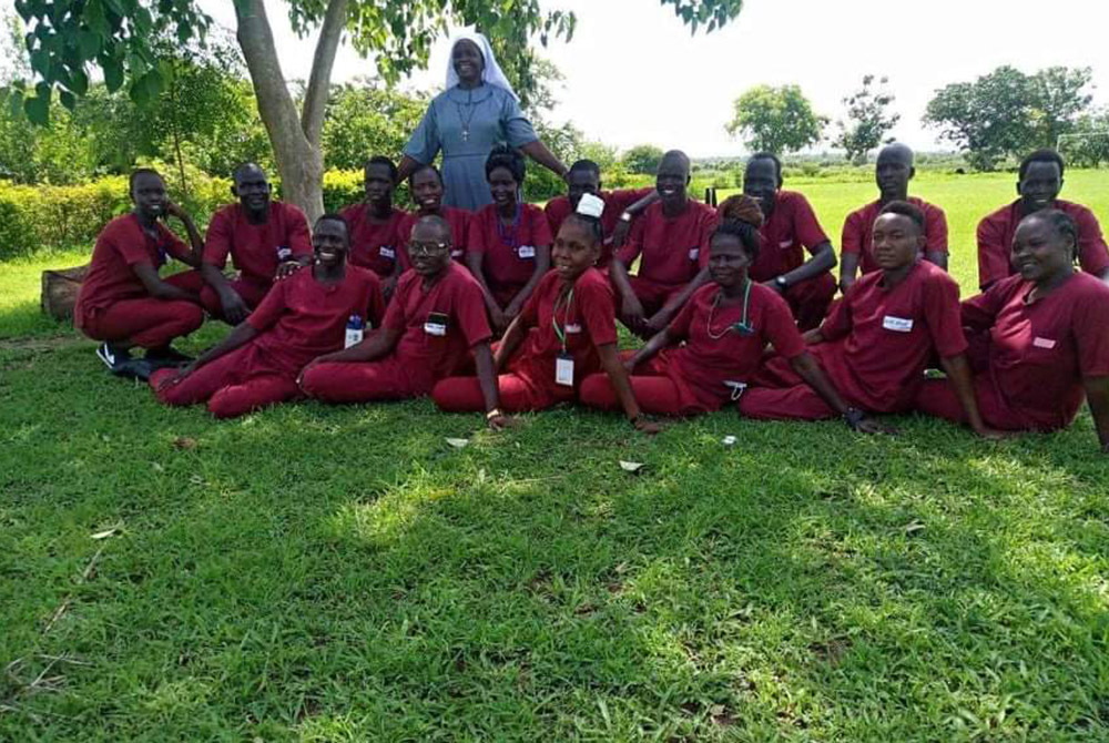 Sr. Regina Roba, in blue, with students from the Catholic Health Training Institute in Wau, South Sudan. Roba, a Sister of the Sacred Heart in the Juba Archdiocese, was a nurse who tutored students until her death Aug. 16. (Friends in Solidarity)
