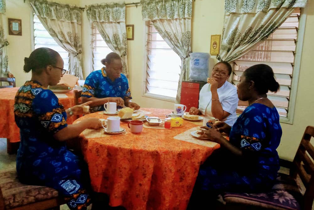 The Religious Sisters of Charity in Lagos, Nigeria, eat breakfast together while maintaining social distancing and avoiding physical contact. (Courtesy of the Religious Sisters of Charity)