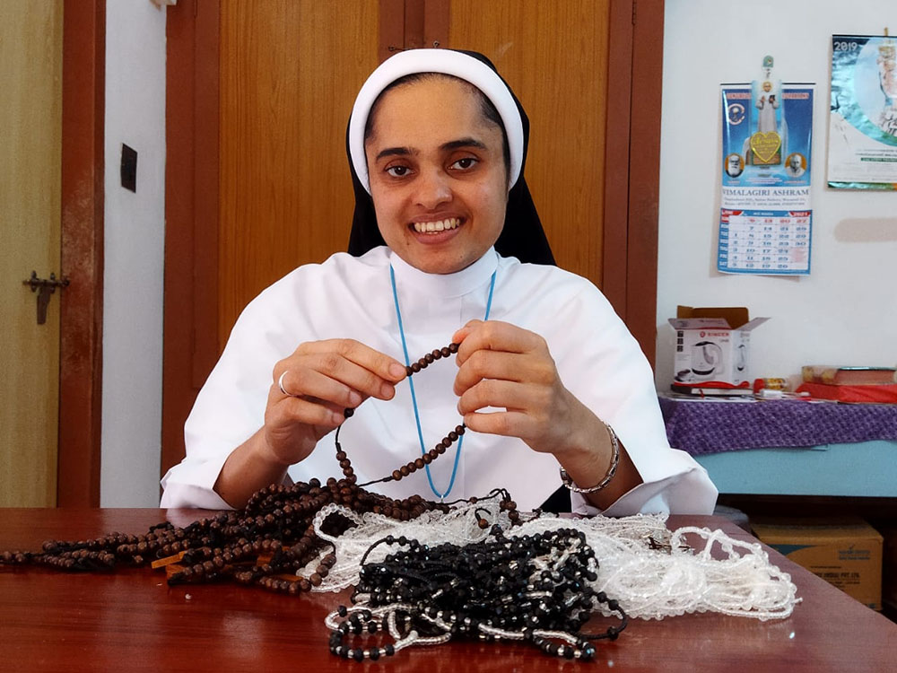 Sr. Rini Rose of the Sisters of the Adoration of the Blessed Sacrament makes rosaries at her community's convent in Ambalavayal, Kerala, India. (Courtesy of the Sisters of the Adoration of the Blessed Sacrament)