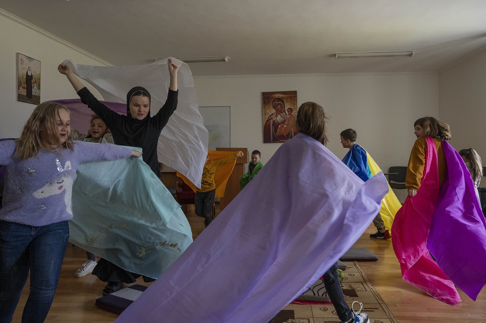 A nun plays with internally displaced children who are taking refuge at the Hoshiv Women's Monastery in Ivano-Frankivsk region, western Ukraine, on April 6. (AP Photo/Nariman El-Mofty)