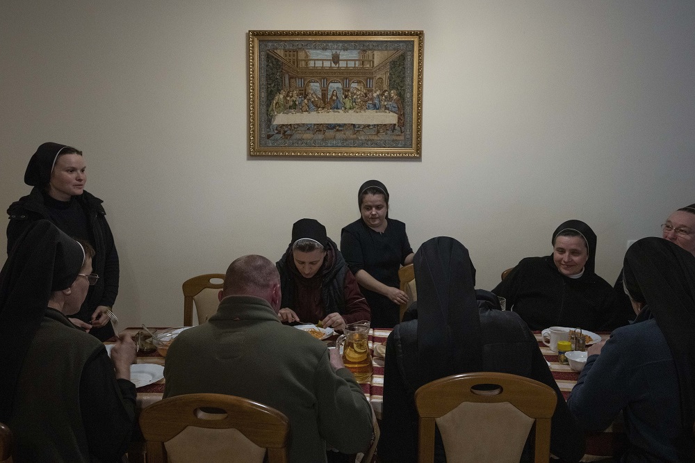 Nuns eat dinner April 6 at the Hoshiv Women Monastery, where they have been taking in internally displaced families fleeing the war in Ivano-Frankivsk region, western Ukraine.