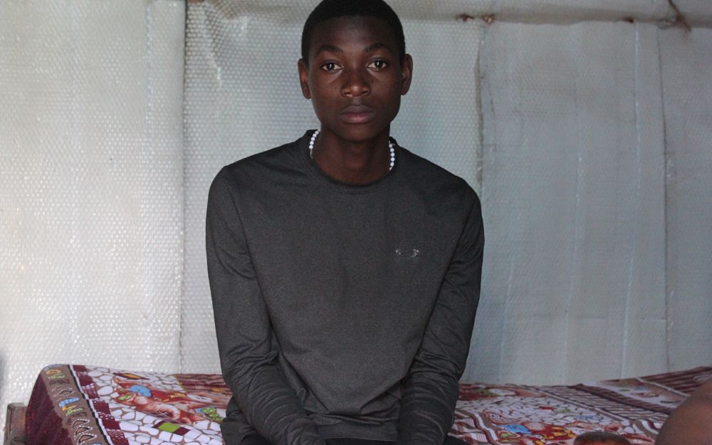 Stanley Joakim sits on his bed as he narrates how his abductors tortured him for three days without giving him either food or water.