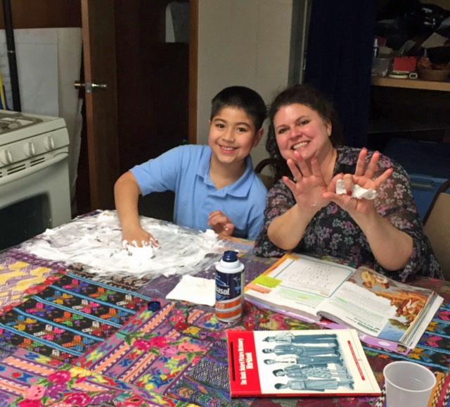 A tutor and a student work together at a migrant center.