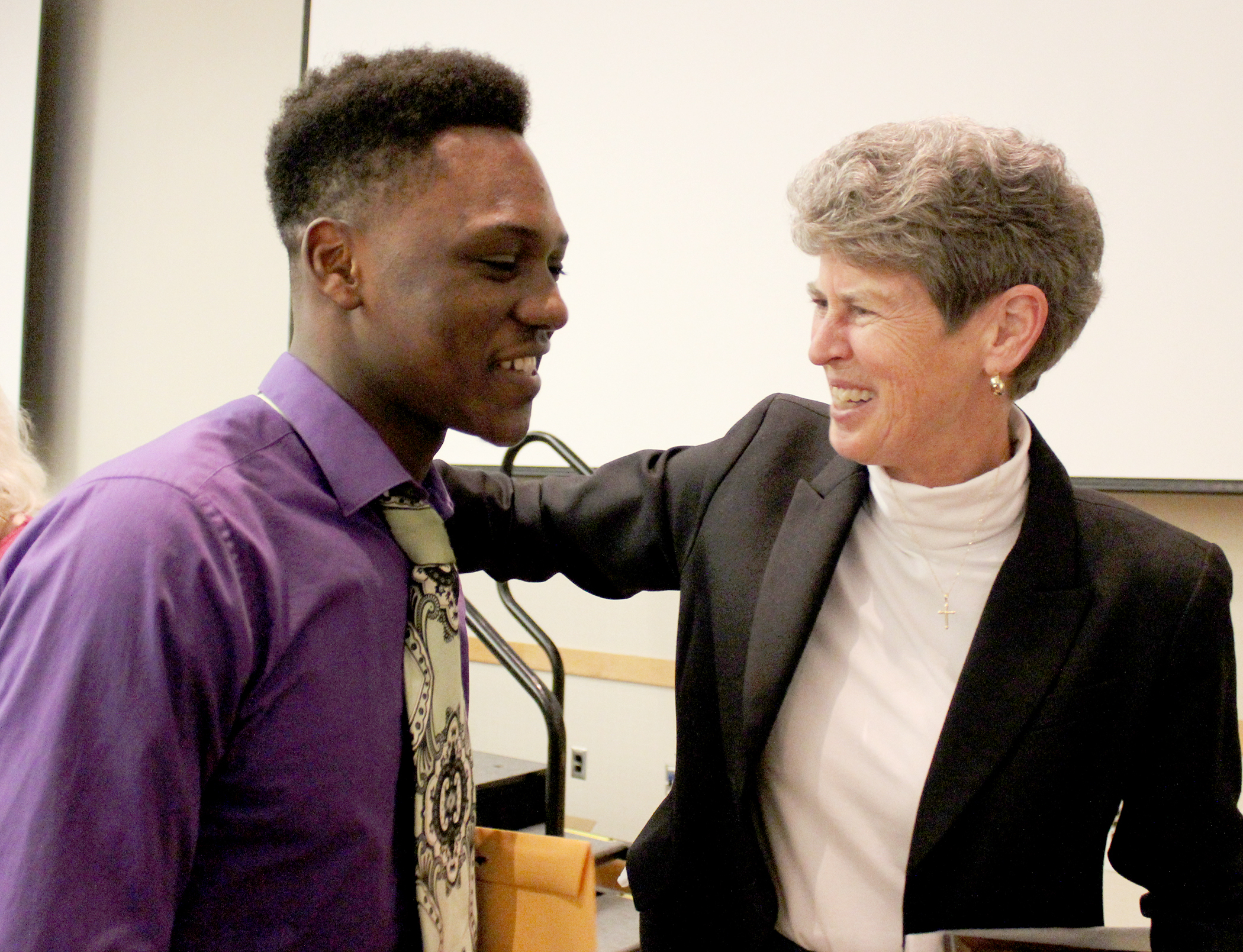 Charity Sr. Sally Duffy congratulates a DePaul Cristo Rey High School student for winning a scholarship in 2016.