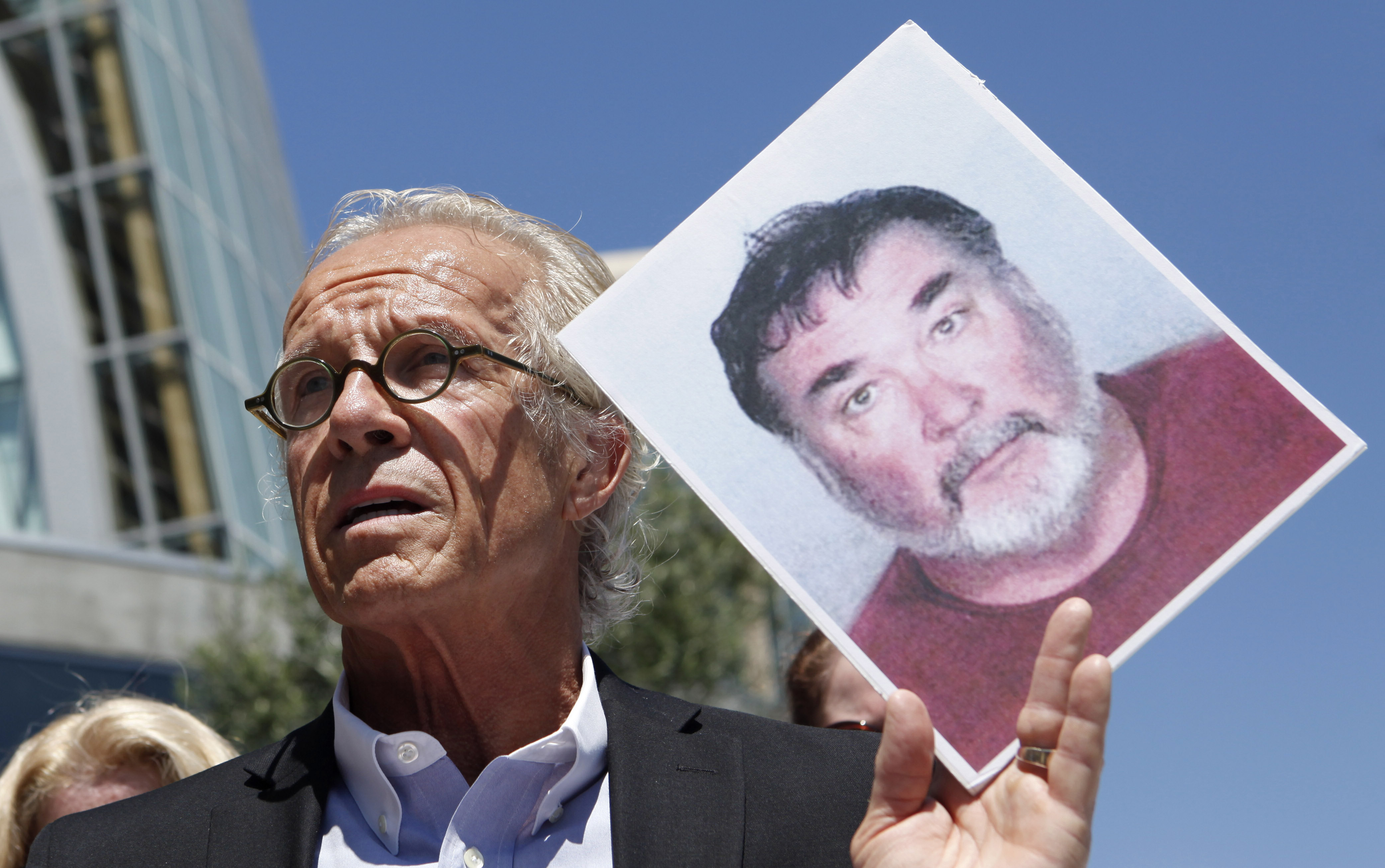 Attorney Jeff Anderson holds up a photo of former priest Stephen Kiesle at a news conference in Oakland, Calif., Wednesday, Aug. 18, 2010. (AP Photo/Jeff Chiu, File)