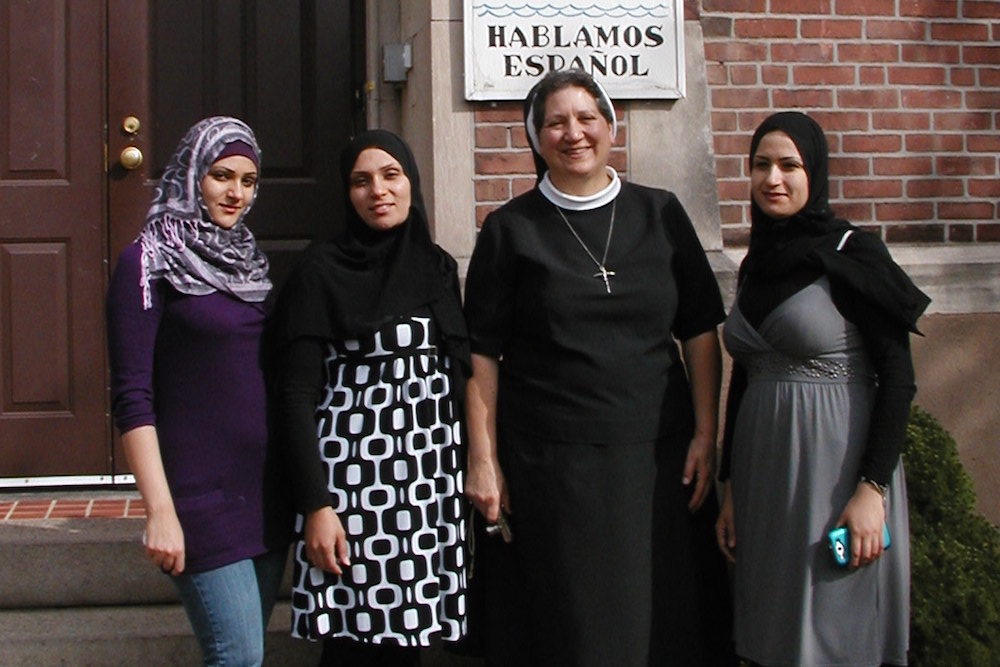Sister Doretta, Apostle of the Sacred Heart of Jesus, poses with clients of the community immigrant services center in New Haven Connecticut. (Apostle Immigrant Services)