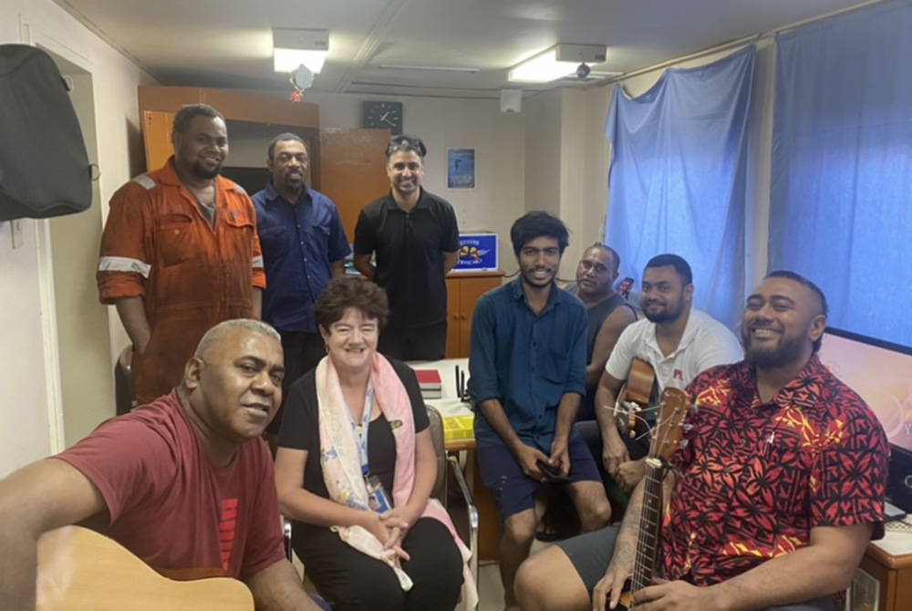 Sr. Mary Leahy (bottom row, second from left) smiles with members of the crew of the M/V Southern Moana ship, who are from Fiji, India, Sri Lanka, Myanmar and Singapore, shortly after conducting an Easter Communion service in their mess room on April 3, H