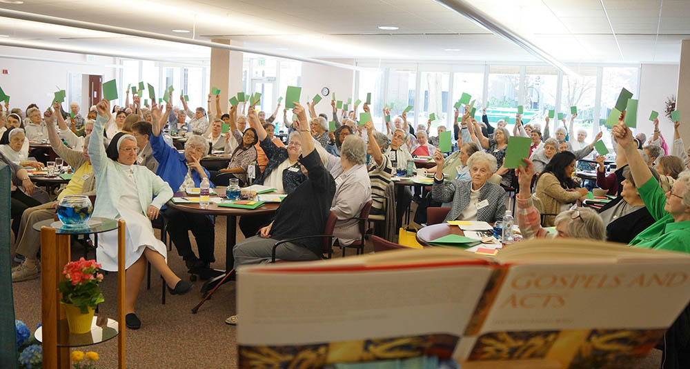 The Dominican Sisters of Springfield, Illinois, affirm a communal decision during a 2019 community meeting. (Courtesy of Beth Murphy)