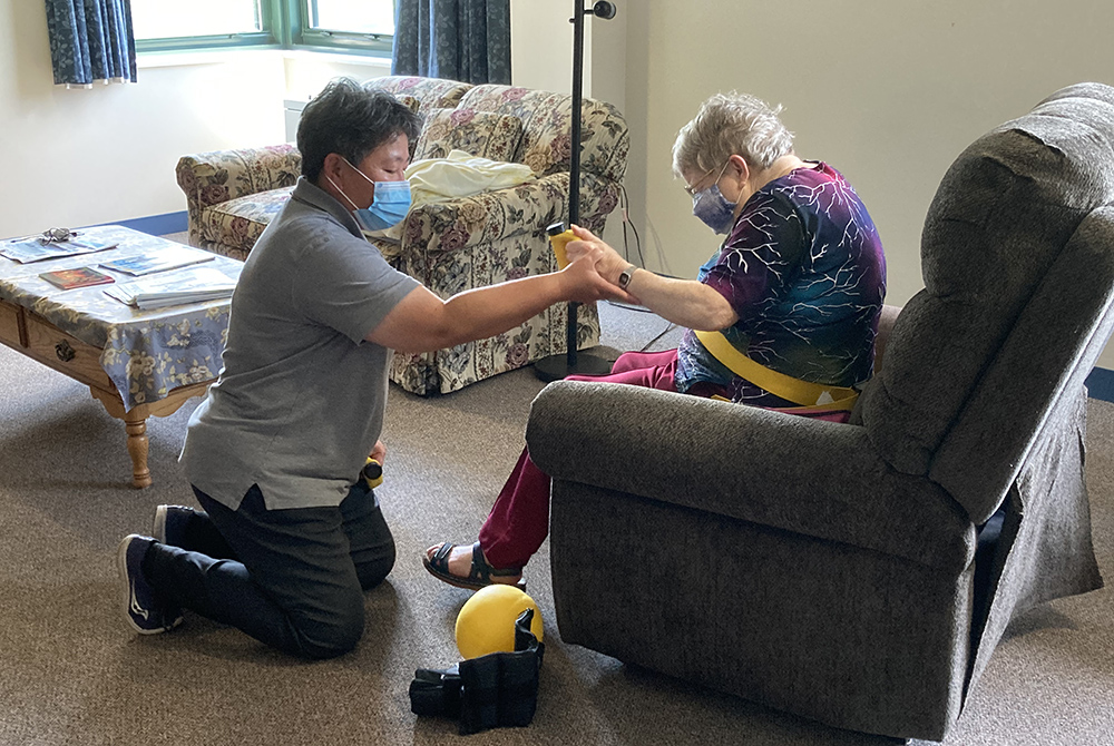 Sr. Cristina Soyao works with a patient. (Courtesy of Franciscan Sisters of the Sacred Heart)