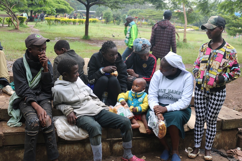 Sr. Caroline Ngatia shares a light moment with homeless boys on the streets of Nairobi, Kenya. (GSR file photo)
