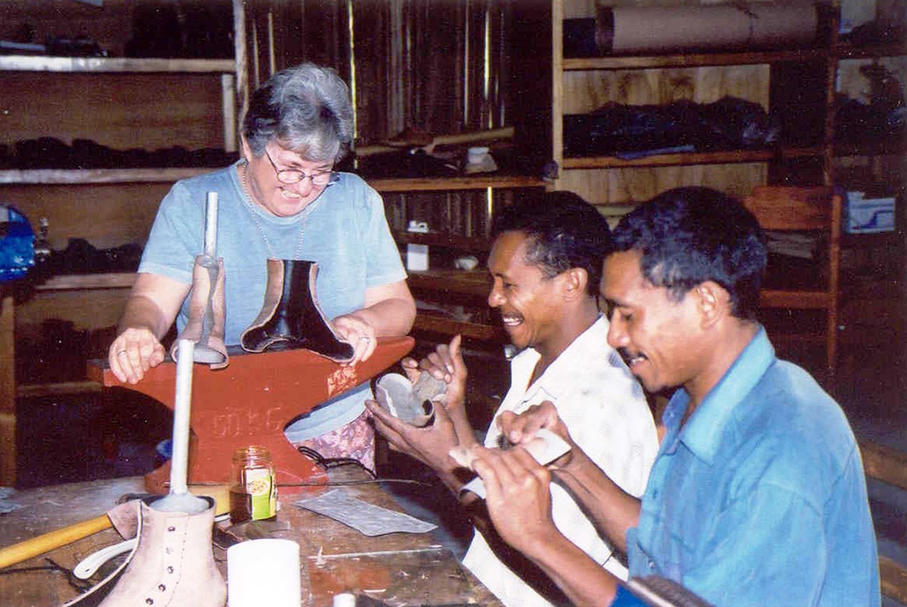 Sr. Susan Gubbins makes a prosthesis with men during her ministry in East Timor. (Courtesy of Susan Gubbins)