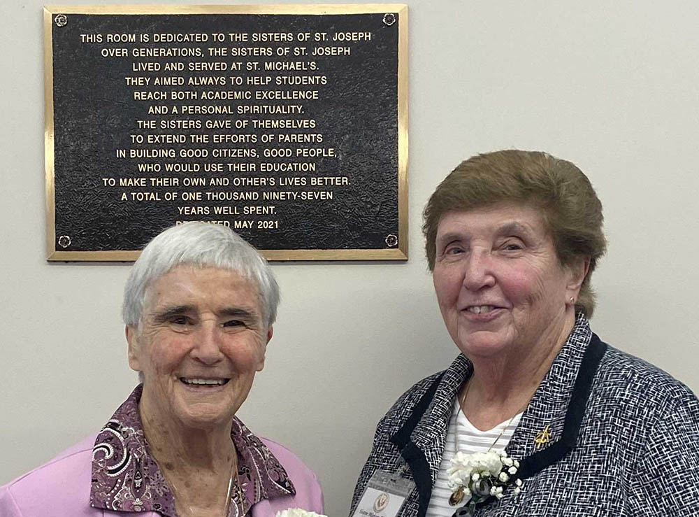 Sr. St. William, left, and Sr. Miriam Blake, the last Sisters of St. Joseph of Brentwood, New York, to staff St. Michael's Catholic Academy as administrators, attend the May 26 dedication of the plaque in the school's faculty room.