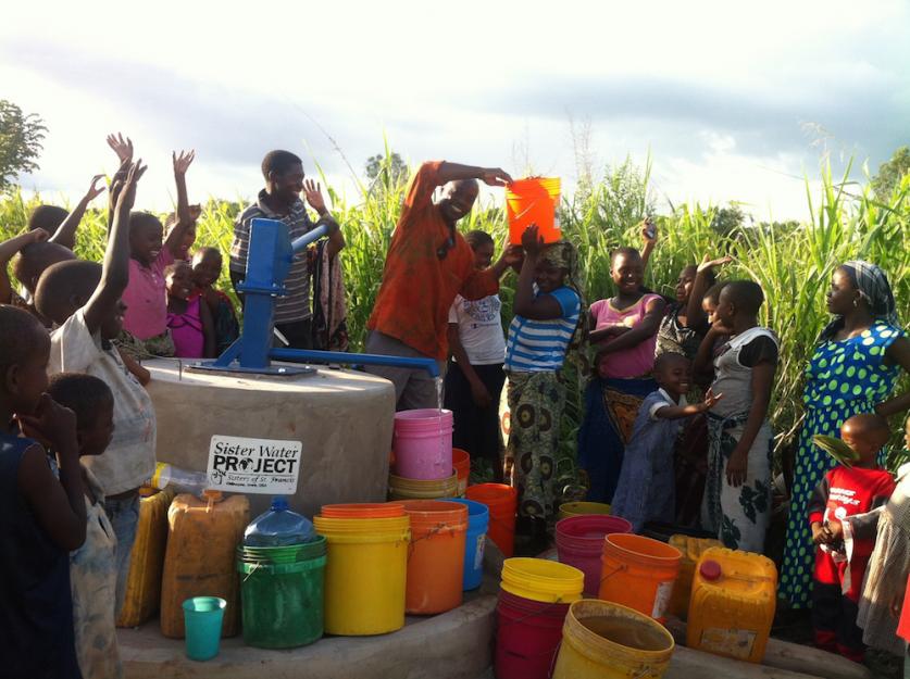 People in Tanzania rejoice at the opening of a well providing fresh, clean drinking water.