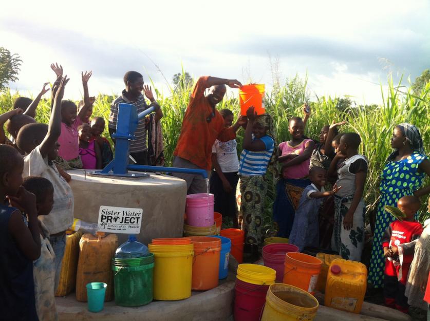 People in Tanzania rejoice at the opening of a well providing fresh, clean drinking water. People in Tanzania rejoice at the opening of a well providing fresh, clean drinking water.