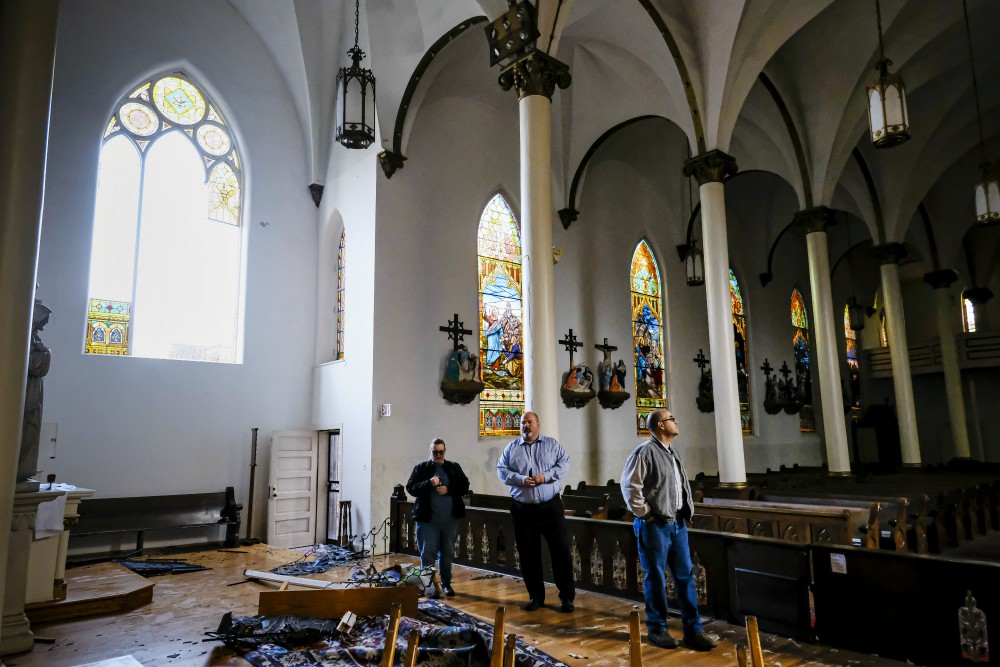 People look over the damage to the Church of the Assumption following a March 3 tornado in Nashville, Tennessee. (CNS / Tennessee Register / Rick Musacchio)