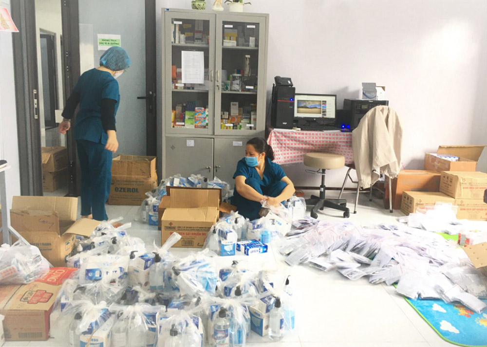 Sr. Teresa Le Thi Tien, right, and another sister prepare bags of medicine for COVID-19 patients at Kim Long Charity Clinic in Kim Long ward in Hue, Vietnam. (Courtesy of the Filles de Marie Immaculée)