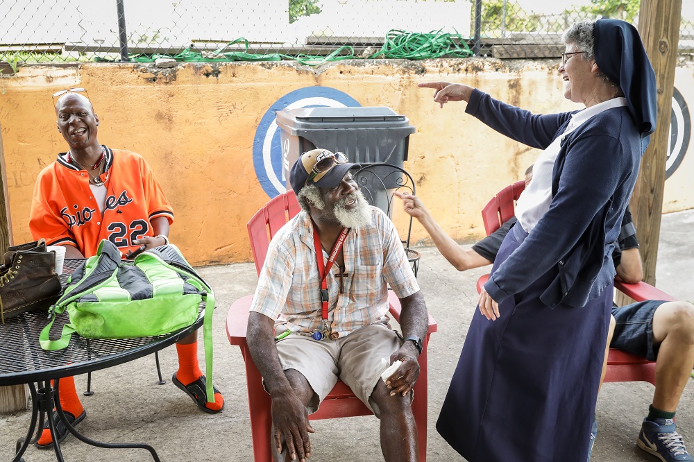 Sr. Theresa Sullivan talks to Ocie, who she says always adds a spark to her day, at Daybreak Day Resource Center in Macon, Georgia. (Provided photo)