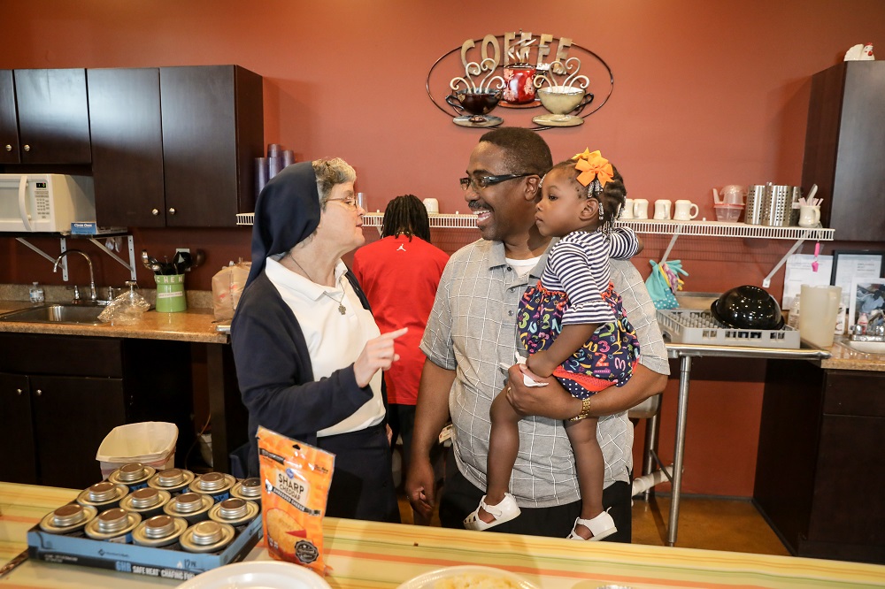 Sr. Theresa Sullivan, left, thanks Reverend Spencer for the meal his congregation provides at Daybreak Day Resource Center in Macon, Georgia, each month. (Provided photo)