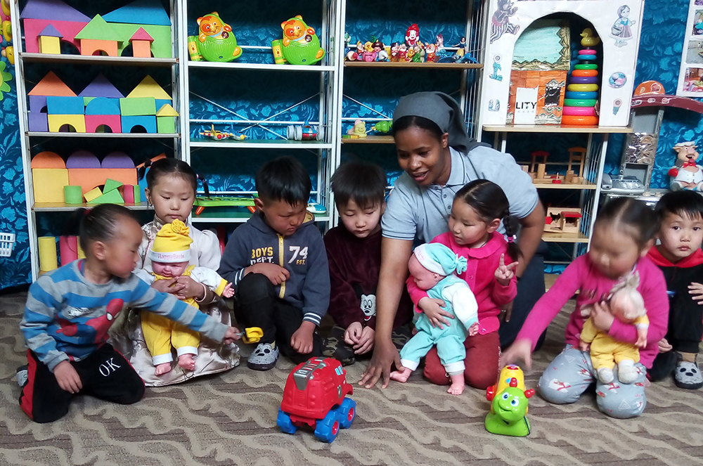 Sr. Tireza Gabriel Usamo plays with children at a day care center run by Consolata Missionaries. (Courtesy of Tireza Gabriel Usamo)