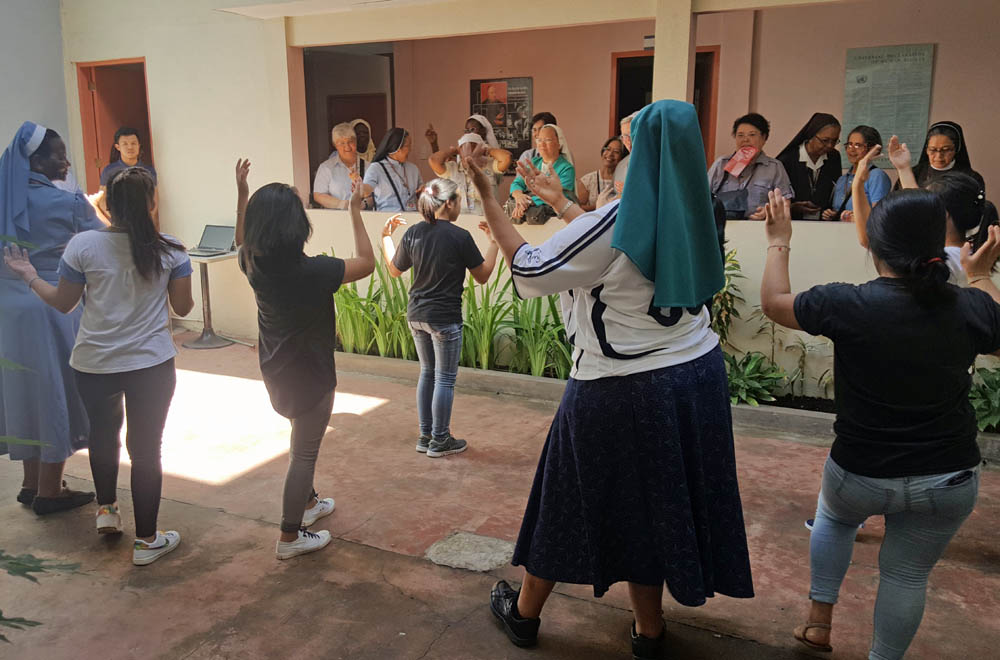 In this 2017 photo, Sr. Letta Mosue, in black skirt, and Sr. Josephine Mpatane, far left, join a dance performance by young women at the Ruhama Center for Women, a residential facility for young women rescued from trafficking and abuse in Manila. (GSR) In this 2017 photo, Sr. Letta Mosue, in black skirt, and Sr. Josephine Mpatane, far left, join a dance performance by young women at the Ruhama Center for Women, a residential facility for young women rescued from trafficking and abuse in Manila. (GSR)