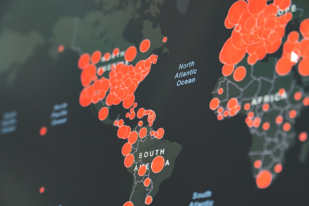 World map showing red circles of coronavirus infections