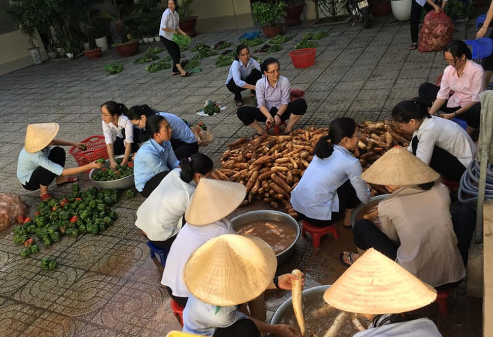 Dominican sisters in Ho Chi Minh City, Vietnam, prepare raw fruits and roots in their motherhouse's yard before giving them to people affected by COVID-19. (Courtesy of Mary Nguyen Thi Minh Du)