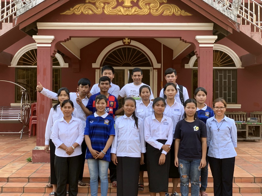 Fr. Father Ivan Campaña (center back row), Sr. Sokny Nheb (front left ) and Sr. Hill Pen (front right) with young adults in front of the church in Stung Treng, Cambodia (Akarath Soukhaphon)