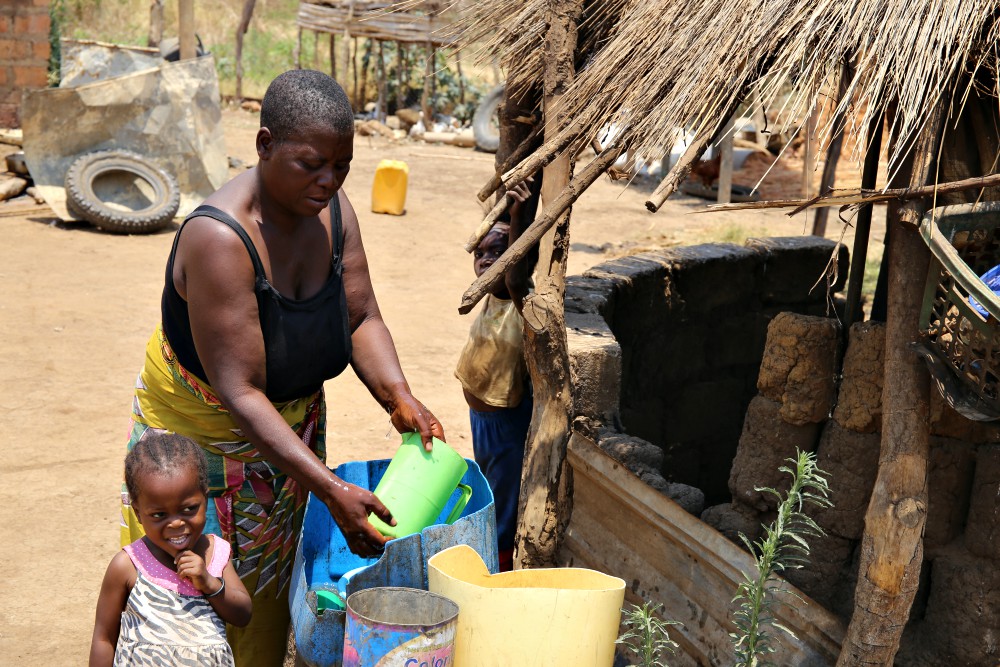 Jane Muma, 39, and two of her children work outside their rural home in the outskirts of Chilanga town in Zambia. She is among families who have been trained by sisters in organic farming. (GSR photo/Doreen Ajiambo) Jane Muma, 39, and two of her children work outside their rural home in the outskirts of Chilanga town in Zambia. She is among families who have been trained by sisters in organic farming. (GSR photo/Doreen Ajiambo)