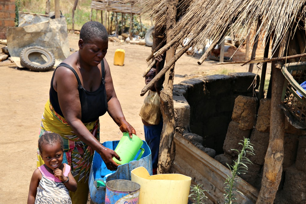 Jane Muma, 39, and two of her children work outside their rural home in the outskirts of Chilanga town in Zambia. She is among families who have been trained by sisters in organic farming. (GSR photo/Doreen Ajiambo)