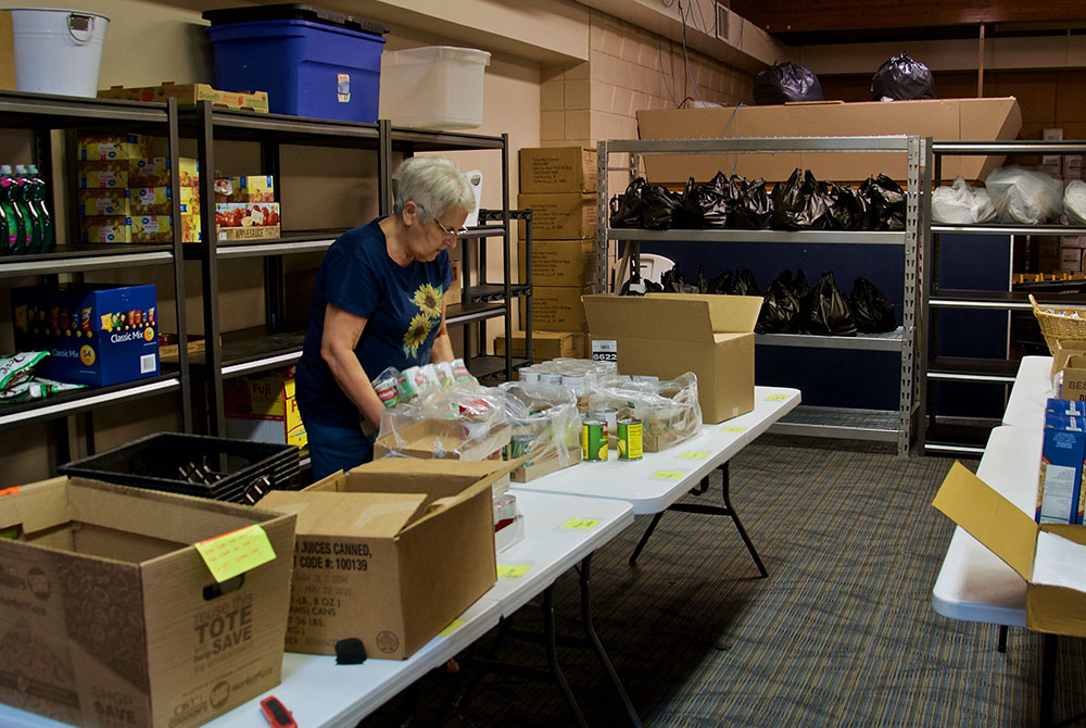 A volunteer organizes donations at the Ministry on the Margins food pantry in Bismarck, North Dakota. (GSR photo/Dan Stockman)