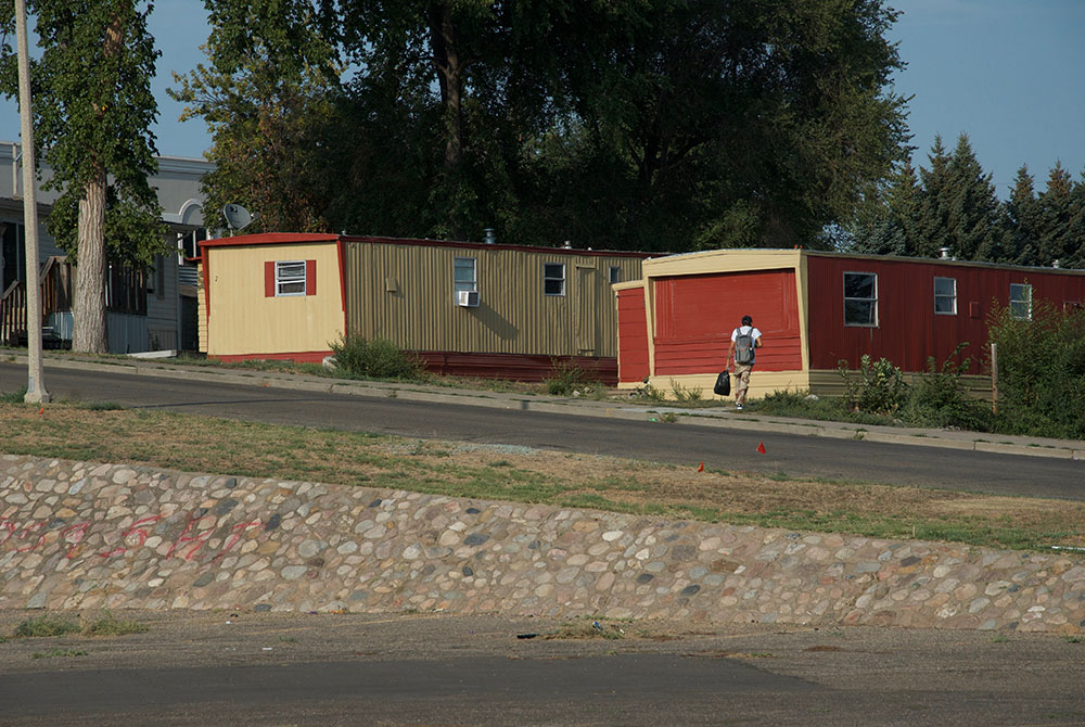 Mobile homes bake in the summer sun across the street from the food pantry at Ministry on the Margins in Bismarck, North Dakota. (GSR photo/Dan Stockman)