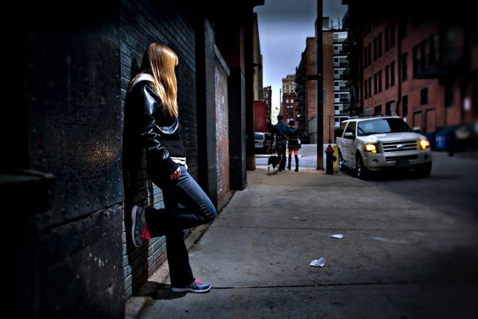 Photo illustration of young woman being trafficked.