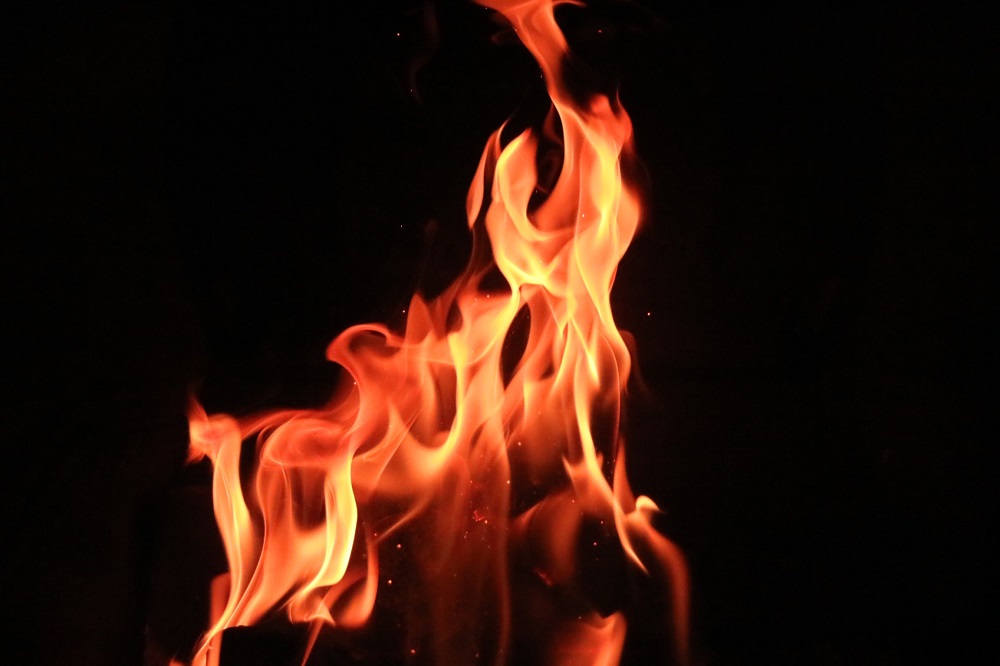 A fire burns against a black background