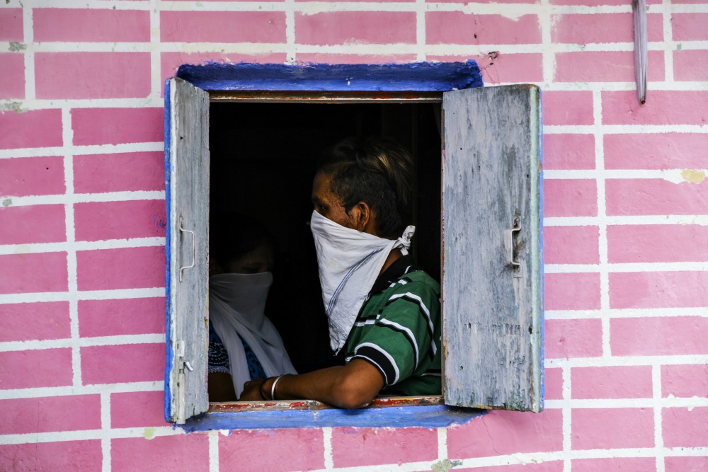 A man covers his face with a handkerchief for coronavirus protection in Mumbai, India, June 17. (Dreamstime/Srinivas Akella Ramalingaswami)