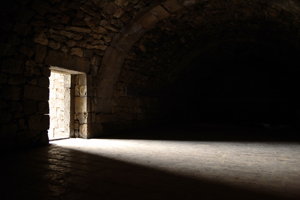 Light shining through a monastery door (Dreamstime/Arevhamb)