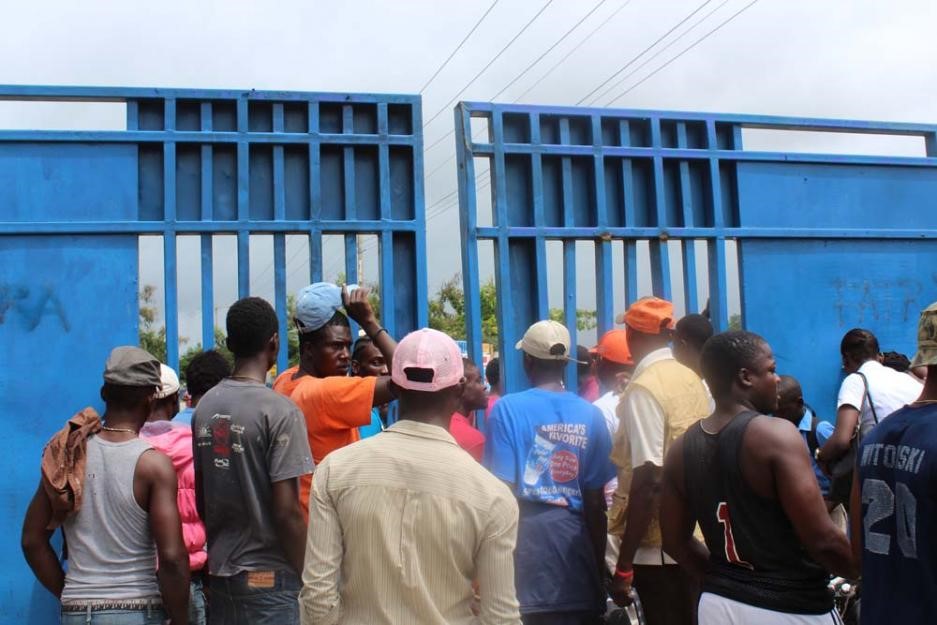 People gather at a border crossing between Haiti and the Dominican Republic.