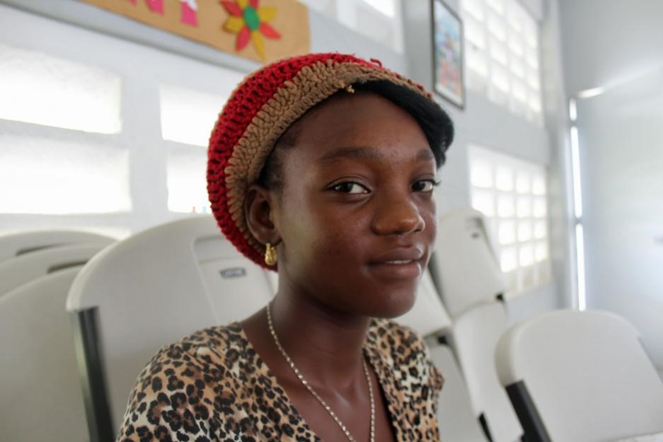 Prospelanda Aime smiles inside a church-run shelter.