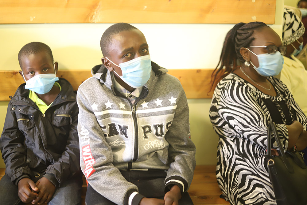 Patients sit on the benches along the hospital corridors as they wait to be attended to by the doctor at St. Joseph Hospital June 2 in Gilgil in southwestern Kenya. Dr William Charles Fryda opened the hospital after the fallout between him and the Assumpt