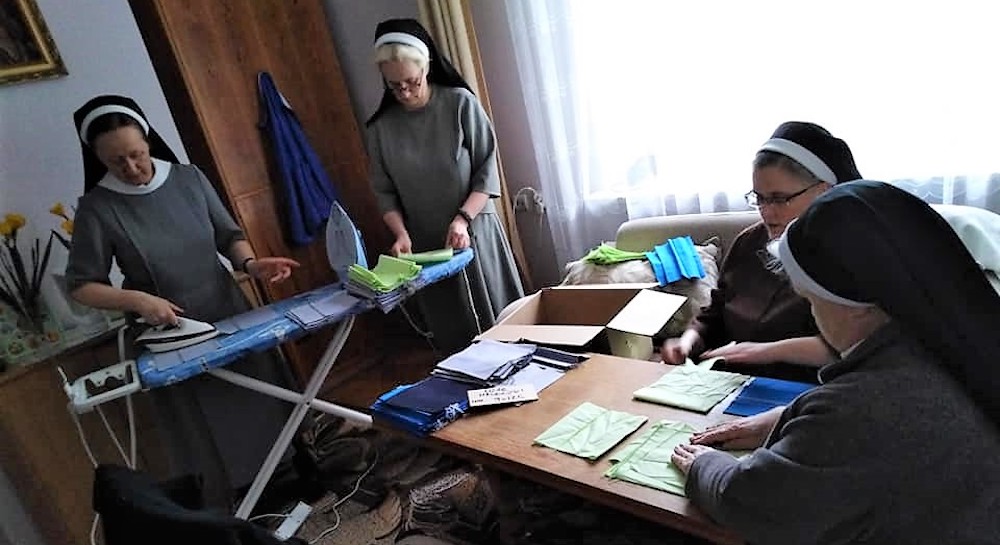 Sisters in Poland in a room making masks