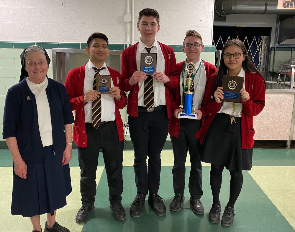 Coach Sr. Alice Hess stands in the school cafeteria next to the students who scored the highest in the 2019 Mathlete competition in the Philadelphia Archdiocese. The Archbishop Ryan High School students are, from left, Matthias Davila, Gabriel Charpentier Coach Sr. Alice Hess stands in the school cafeteria next to the students who scored the highest in the 2019 Mathlete competition in the Philadelphia Archdiocese. The Archbishop Ryan High School students are, from left, Matthias Davila, Gabriel Charpentier